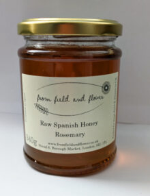 one jar of rosemary honey, sitting against a white background.