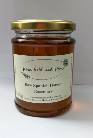 one jar of rosemary honey, sitting against a white background.