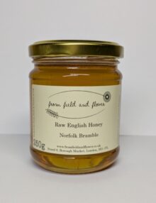 Jar of bramble honey, sitting on a white background.