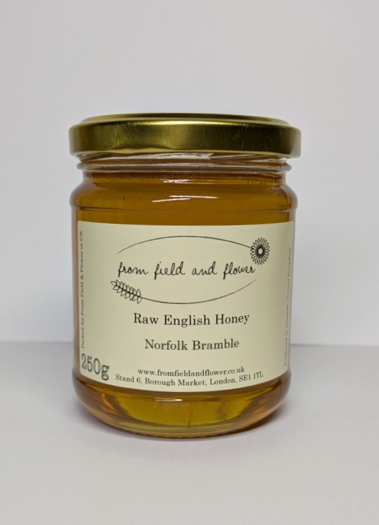 Jar of bramble honey, sitting on a white background.